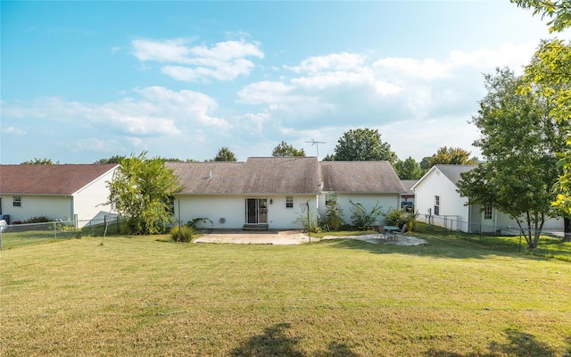 rear view of house featuring a yard and a patio