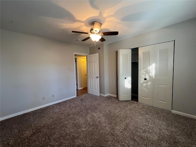 unfurnished bedroom with a textured ceiling, carpet floors, a closet, and ceiling fan