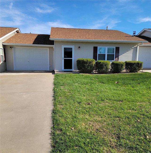 ranch-style home featuring a garage and a front yard