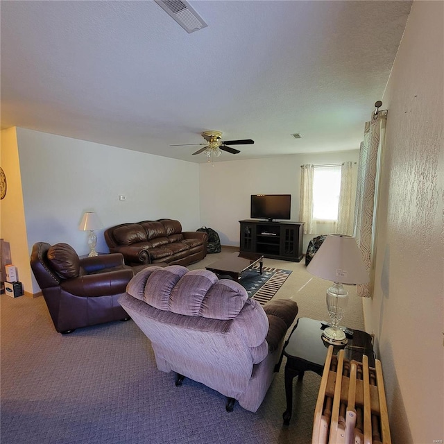 living room featuring carpet floors and ceiling fan