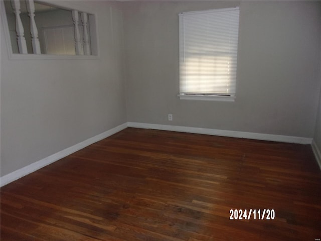 empty room with dark hardwood / wood-style floors