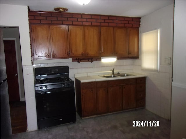 kitchen featuring black gas stove and sink