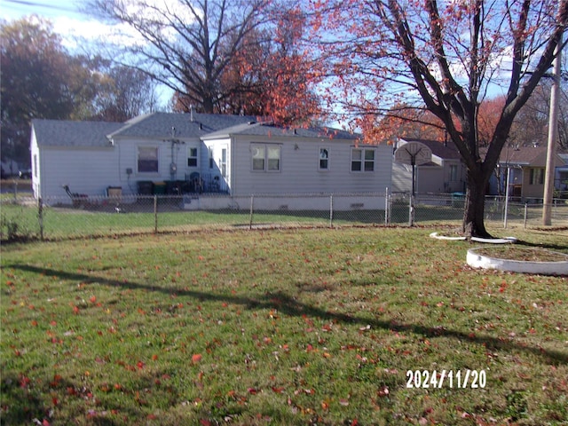 back of house with a lawn