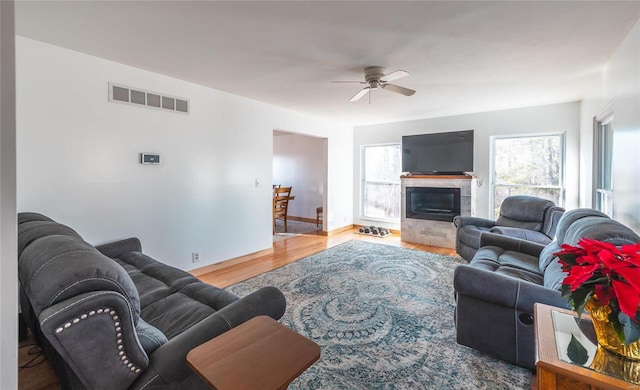 living room featuring wood-type flooring and ceiling fan