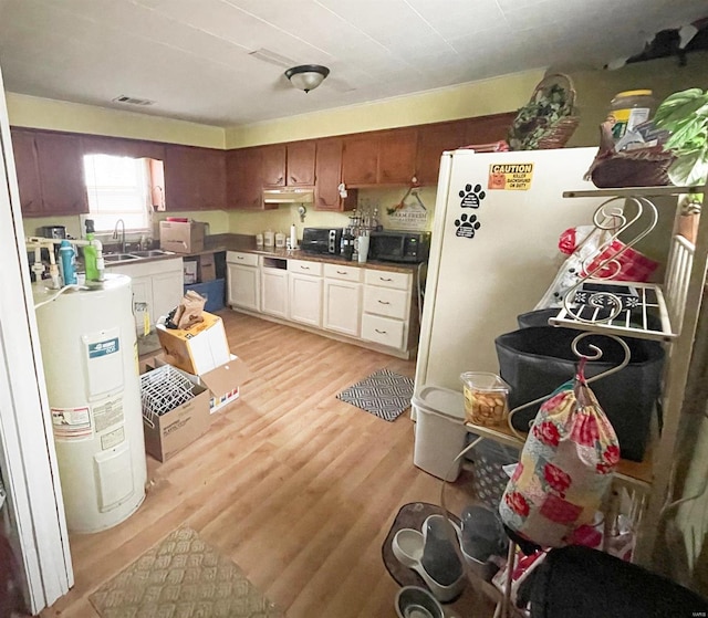 kitchen featuring sink, electric water heater, white fridge, white cabinets, and light wood-type flooring