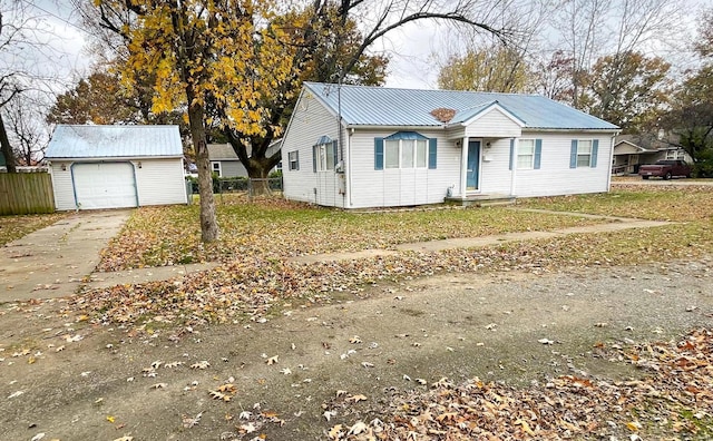 view of front of property featuring a garage and an outdoor structure