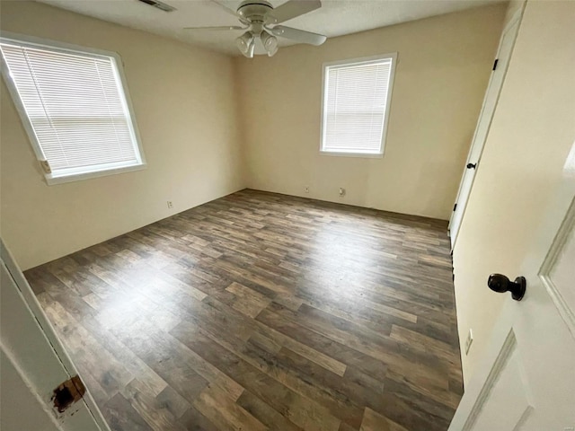 unfurnished room with dark hardwood / wood-style floors and ceiling fan