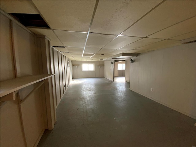 basement with a paneled ceiling