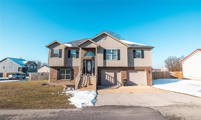 bi-level home with a front yard and a garage