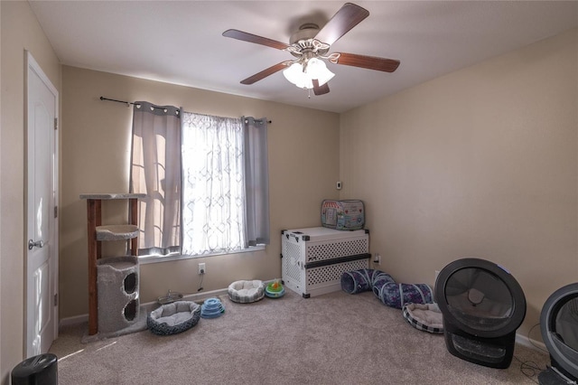 misc room featuring carpet flooring and ceiling fan