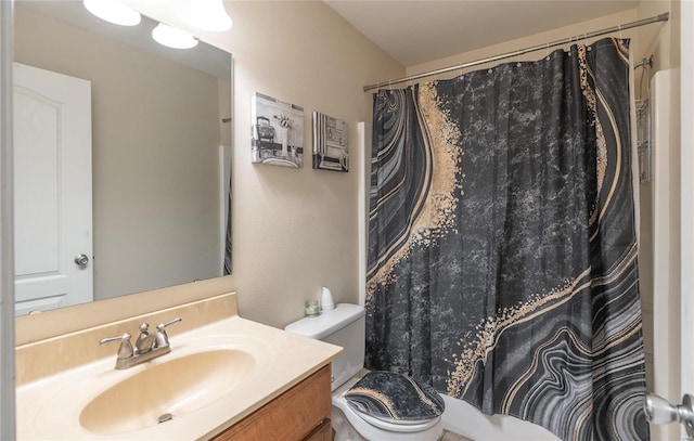 bathroom featuring toilet, vanity, and walk in shower