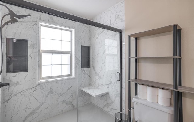 bathroom featuring a healthy amount of sunlight, a shower with door, and toilet