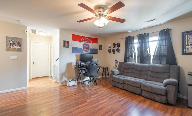 living room featuring ceiling fan and hardwood / wood-style flooring