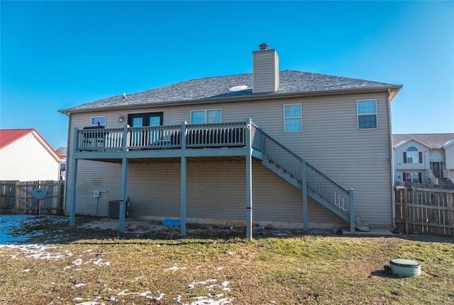 back of property featuring a yard, a deck, and central AC unit