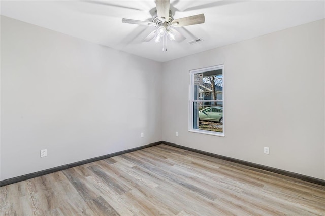 empty room featuring ceiling fan and light wood-type flooring