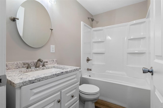 full bathroom featuring shower / bathing tub combination, wood-type flooring, vanity, and toilet