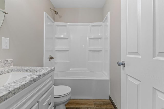 full bathroom with vanity, toilet, wood-type flooring, and bathtub / shower combination