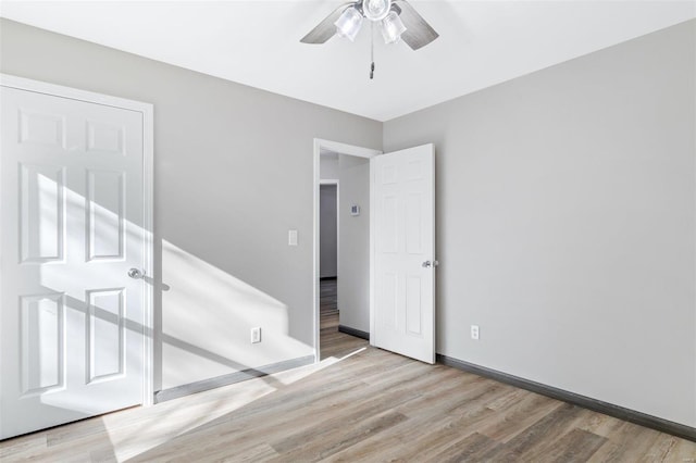 unfurnished room featuring ceiling fan and light hardwood / wood-style floors