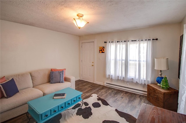 living room with dark wood-type flooring, a textured ceiling, and a baseboard heating unit