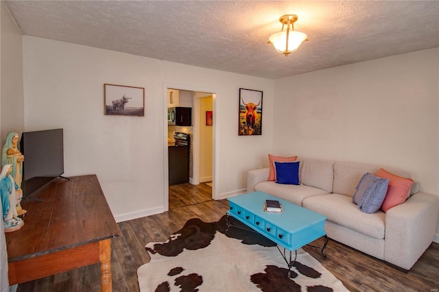 living room featuring dark hardwood / wood-style flooring and a textured ceiling