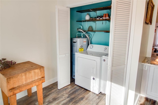 clothes washing area featuring dark hardwood / wood-style floors, washer and clothes dryer, and water heater