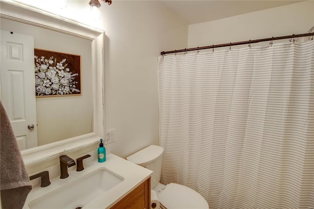 bathroom featuring vanity, curtained shower, and toilet