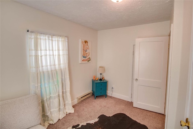 carpeted bedroom with a baseboard radiator and a textured ceiling