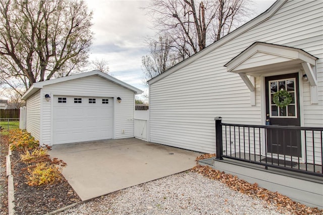 view of side of property with a garage and an outbuilding