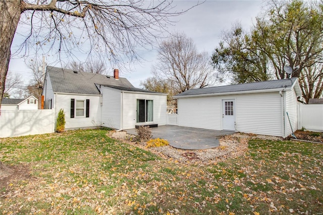 rear view of property featuring a yard and a patio