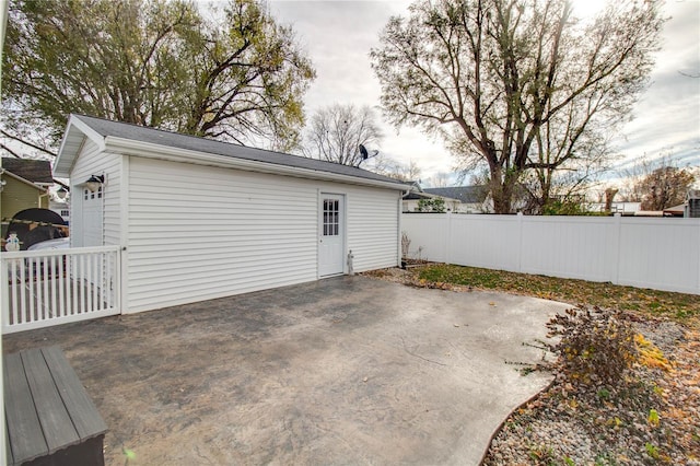 view of patio featuring a garage and an outdoor structure