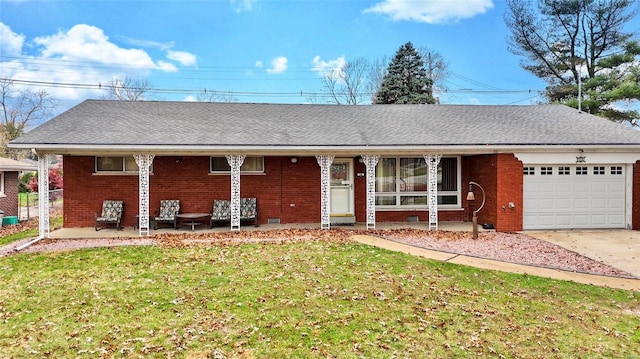 ranch-style home with a garage, brick siding, a front lawn, and a shingled roof