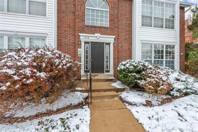 view of snow covered property entrance