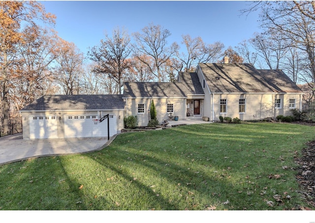 view of front facade featuring a garage, a front yard, concrete driveway, and a chimney