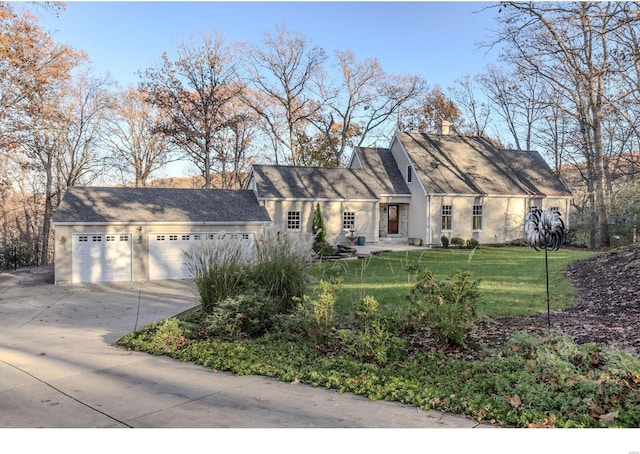 view of front facade with an attached garage, a chimney, concrete driveway, and a front yard