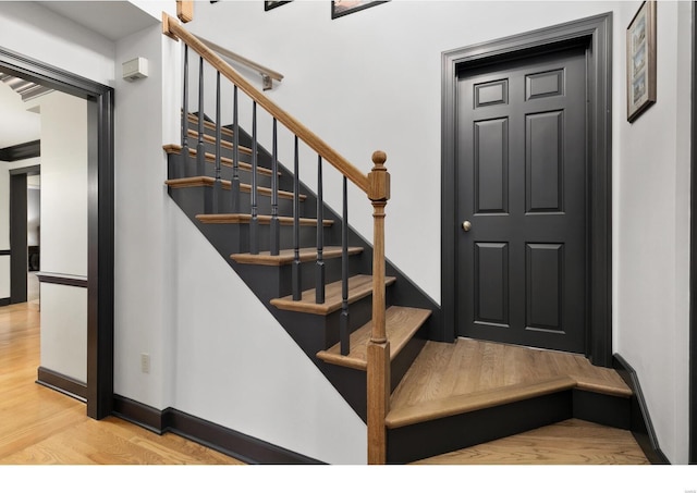 stairs featuring baseboards and wood finished floors