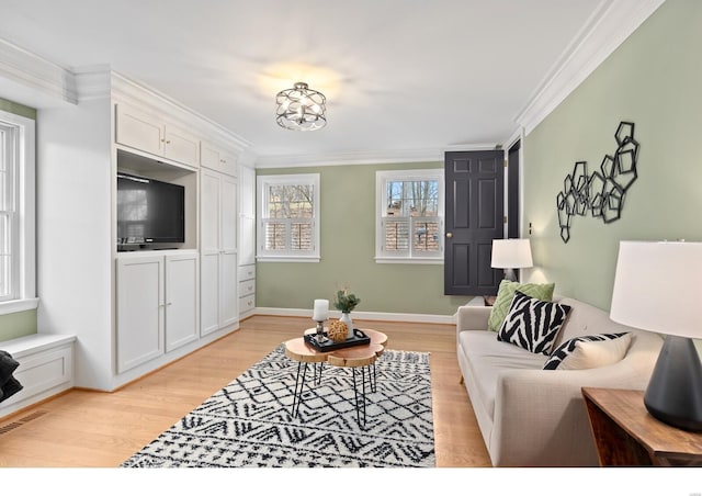 living area featuring light wood finished floors, visible vents, and crown molding