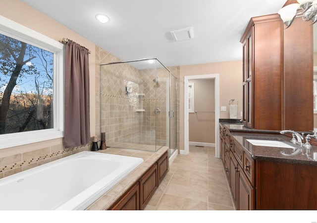 full bathroom with a garden tub, a sink, tile patterned floors, double vanity, and a stall shower