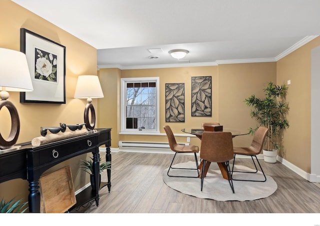 dining area with baseboards, light wood-style flooring, and crown molding