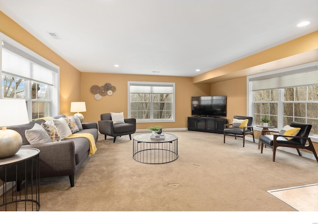 living room with carpet, visible vents, baseboards, and recessed lighting