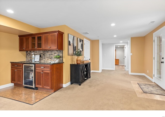 kitchen with recessed lighting, visible vents, decorative backsplash, light carpet, and beverage cooler