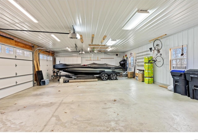 garage with a garage door opener and metal wall