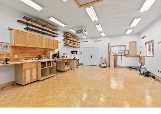 interior space featuring baseboards and a workshop area