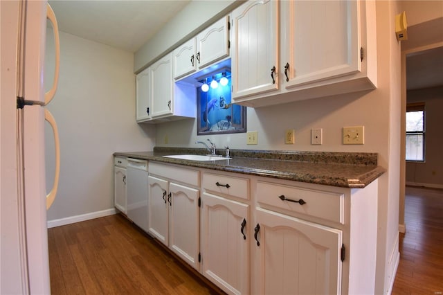 kitchen with dark hardwood / wood-style flooring, white appliances, white cabinetry, and sink