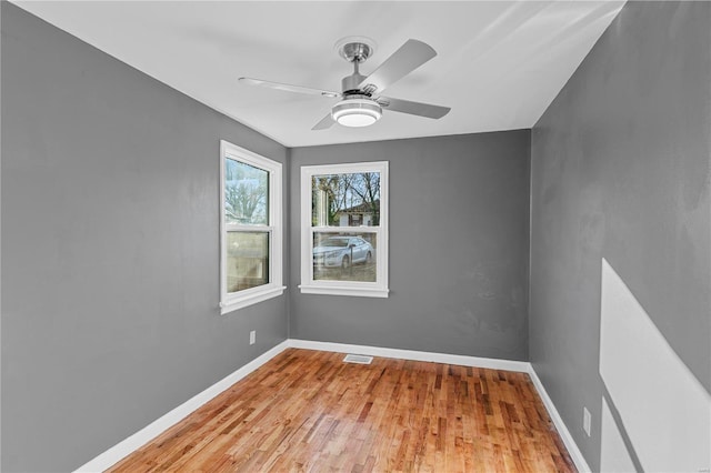 spare room featuring light hardwood / wood-style floors and ceiling fan