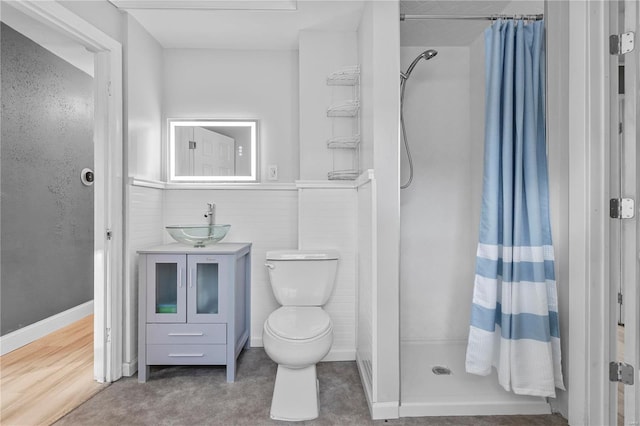 bathroom featuring vanity, toilet, and walk in shower