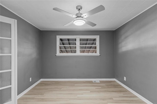 spare room with light hardwood / wood-style flooring, ceiling fan, and crown molding