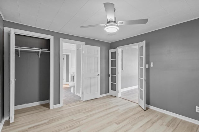 unfurnished bedroom featuring ceiling fan, a closet, and light hardwood / wood-style flooring