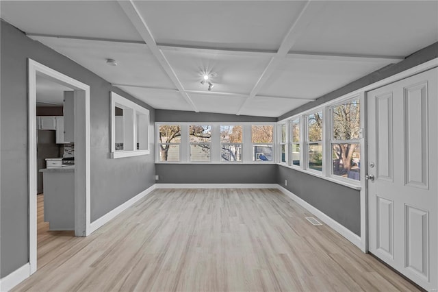 unfurnished sunroom with beam ceiling, a wealth of natural light, and coffered ceiling