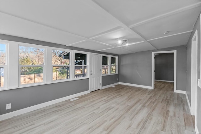 spare room with coffered ceiling and light wood-type flooring