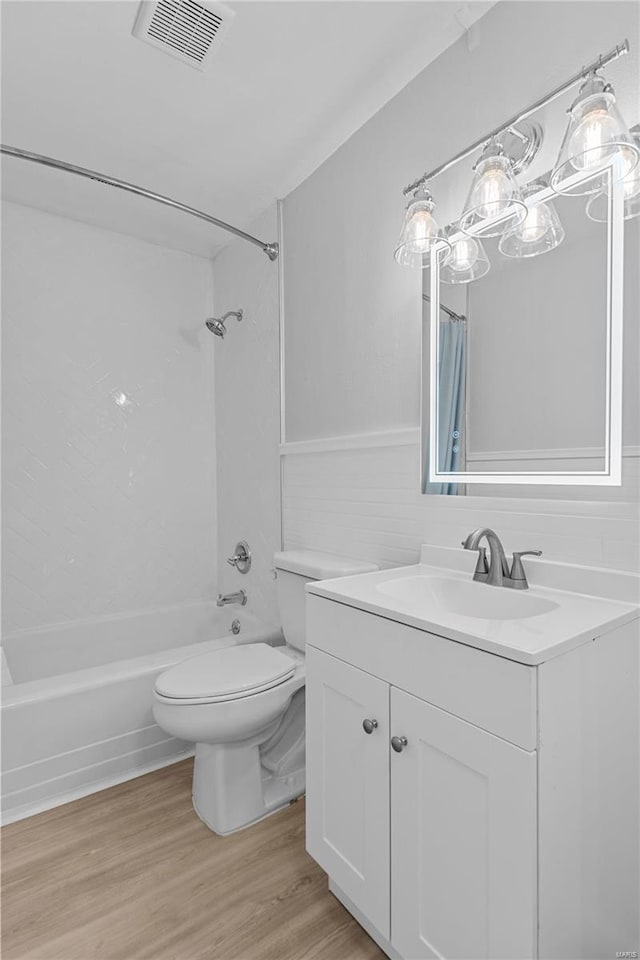 full bathroom featuring wood-type flooring, vanity, toilet, and shower / bath combo with shower curtain